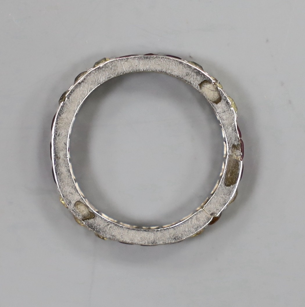 A white metal and gem set eternity ring, size L/M, gross weight 2.6 grams.